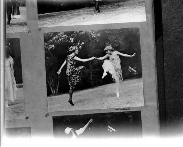 Copy negative of Julia Hanks and another woman dancing on the grass at the University of Wisconsin.