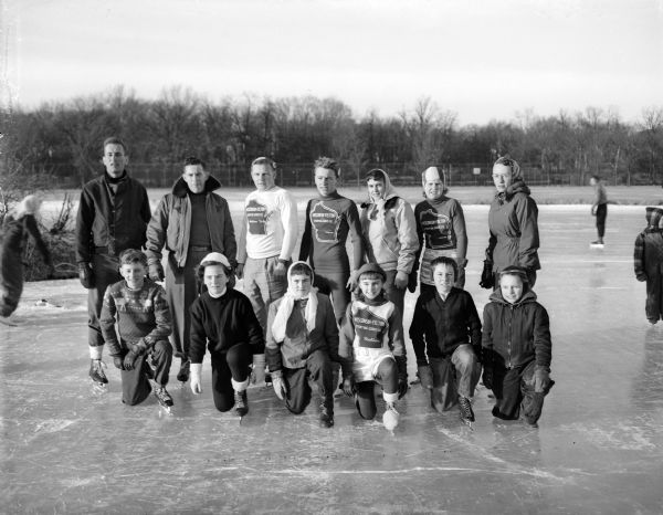 Group portrait of the title winners in the all-city skating championships at Vilas Park. Shown on the ice are, from left to right:  (front row) John Glidden, Patricia Macken, Beverly Roth, Susanne, Devine, Duane Riley, Tom Thorson, (back row) Pete Ganshert, Don Chase, Jim McFarlane, Dick Simonson, Marilyn Roth, Patsy Gibson, and Charlotte Quinlan.