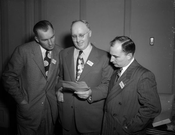Madison Builders Association Three men from the Madison Builders Association gather to look at notice informing the men that their organization is the fastest growing of its kind in the nation. They are, from left to right: Bernard F. Killian, association secretary; Edward B.A. Sokoloski, association president; C.J. Goucher, association vice president.
