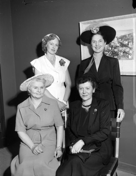 Officers of the women's auxiliary of the Wisconsin Veterinary Medical Association posing for a group portrait. Sitting are Mrs. F.W. Milke, Milwaukee, president for the coming year; Irene Reading, first vice-president; standing Mrs. Rolland Anderson, Elkhorn, second vice-president, left and Mrs. Carl. A. Brandly, Madison, retiring president.