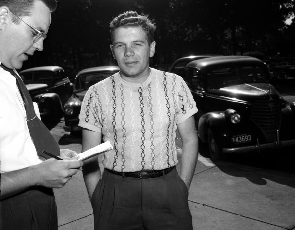 Journalist John Prindle, left, doing an on-the-street interview with Conrad Druse, veteran and University of Wisconsin graduate student, about his opinions on the Korean War.