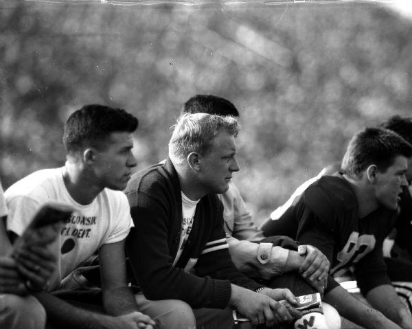 Wisconsin vs. Marquette Football Game Wisconsin player Bill Gable (left), who was lost for the season with a knee injury, watches from the sideline during the football game between Wisconsin and Marquette. Also in the picture is Tom Proctor, #93 at the right.