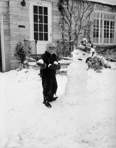 Danny Sinykin and His Snowman Winter scene with seven year-old Danny Sinykin, son of Attorney and Mrs. Gordon (Dorothy) Sinykin, outside his home at 2741 Mason Street with the snowman he built.
