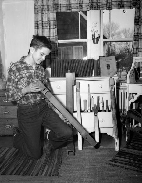Thirteen-year-old Jim Koehler of 2408 Chamberlain Avenue works on making himself a pipe organ in his home workshop.