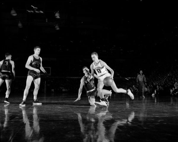 Wisconsin-Michigan Basketball Action University of Wisconsin's guard Al "Ab" Nichols dribbles the ball against Michigan's Jim Skala in a Big Ten game at the University of Wisconsin-Madison Field House.