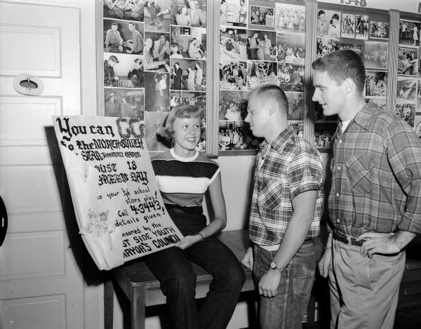 North-South Football Game Poster Three Madison high school youths admire a poster describing the North-South All-Star high school football game to be held in Green Bay. From left to right: Donna Herried, Richard Krier, and Roger Staven.