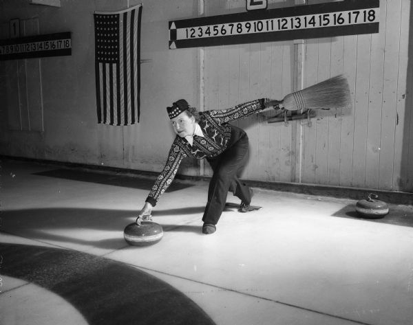 Esther Onstad releases the "stone" on the curling court. Onstad is a member of the Madison Toories, a women's curling group.