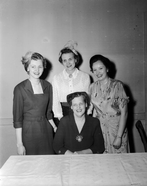 Portrait of four officers of the Southern Wisconsin Dental Assistants' Association. The president, Mrs. Florence Martin, is seated. Other elected officers are Miss Lois Hammer, treasurer; Mrs. Ruth Ryan, vice-president; and three board of directors members; Mrs. Bessie Boosenberry, Miss Mary O'Dea, and Miss Verda Grumke.