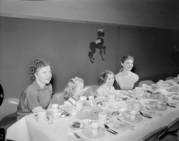 Two of the mothers and daughters pictured at the East Side Women's Club Mother-Daughter Banquet, which had a circus motif, are, left to right: Margaret Alwin and her daughter, Janis Alwin; and Marilyn Sachtjen and her daughter Susan Sachtjen.