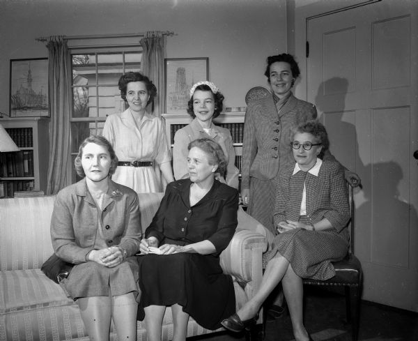 Some of the members of the Madison Democratic Women who are making plans for their conference and spring tea. Sitting, left to right, are: Mrs. E. William Proxmire; Mrs. W. Gorham (Rosamund) Rice, chairman; and Mrs. Floyd (Helene) Wheeler. Standing, left to right, are: Mrs. Llewellyn (Gretchen) Pfankuchen, Mrs. Robert (Hatheway) Brooks, and Mrs. Henry (Virginia) Hart.