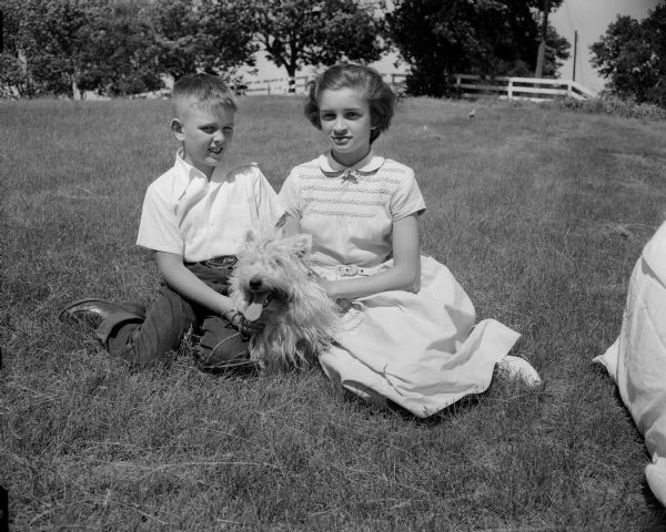 Todd and Janet Gill with their West Highland white terrier, "Buttons."  The dog will be competing in the Badger Kennel Club dog show.
