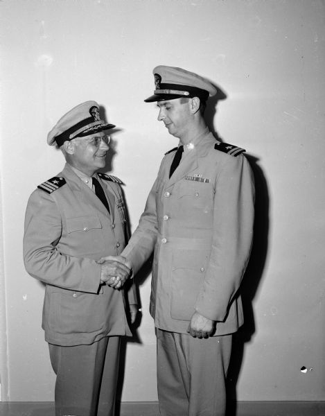 Portrait of Naval Reserve officers Commander Willis M. Greely (left) and Lieutenant Charles H. Haynie. Commander Greely is replacing Lieutenant Haynie as chief of the Madison Naval Reserve unit.