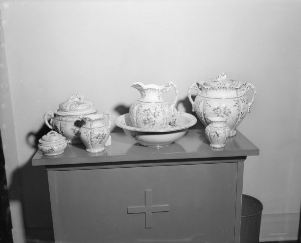 A seven-piece chamber set from the antique collection of Miss Catherine Corscot. The sale of her items was held in Guild Hall at Grace Episcopal Church, 6 North Carroll Street.