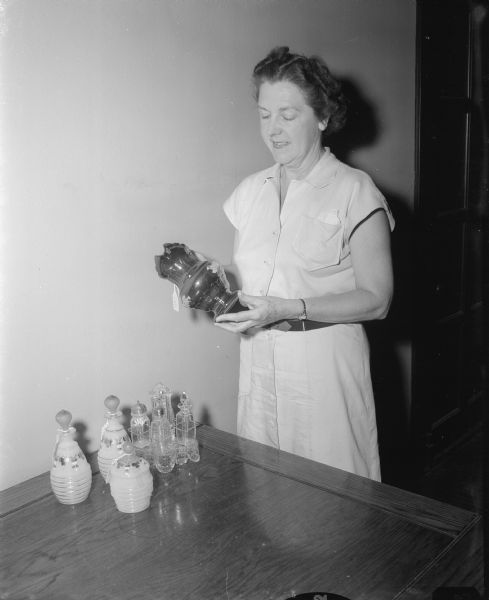 Mrs. Earl (Josephine) Wheeler holds an old lusterware pitcher from the antique collection of the late Miss Catherine Corscot.