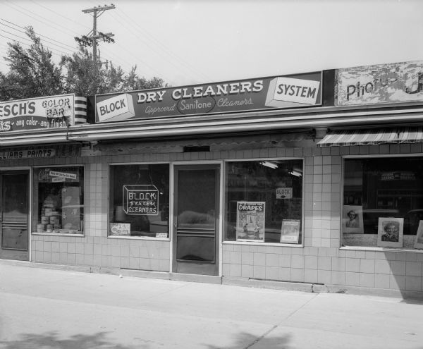Block System, Inc.; Sanitone Dry Cleaners Dry cleaning store at 2434 University Avenue with Flesch's Color Bar paint store at 2436 University Avenue, left, and Jorgenson Photo Studio at 2436 University Avenue, right.