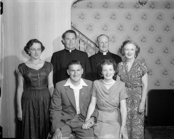 Irish relatives and guest visiting Madison family. Standing left to right are: Miss Mona Salon, the Rev. James Mulvihill, the Rev. John J. Solon, and Mrs. (Mae) Robert C. Grelle. Shown seated in front are Mr. and Mrs. Patrick Pearse Solon. The Solons are Irish cousins of Mrs. Grelle of Madison, Father Mulvihill is an Irish friend of the Solons, now living in Arizona.