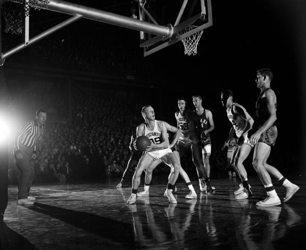 University of Wisconsin vs. Indiana Action shot from the University of Wisconsin vs. Indiana basketball game. Dick Cable (#39) of Wisconsin is surrounded by five players under the basket. Other players are Dan Folz (#53), Tony Stracks (#44), Ron Weisner (#24), Don Schlundt (#34) and Dick Farley (#31).