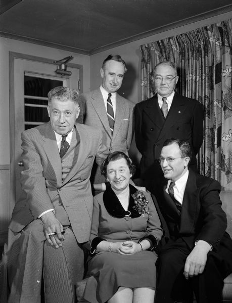 Esther Weddig was the guest of honor at a dinner in her honor for her retirement after thirty-six years of work in the office of the Wisconsin attorney general. Pictured with her, left to right, are: Justice John E. Martin, Attorney General Vernon W. Thomson, Justice Grover Broadfoot, and former Attorney General Thomas E. Fairchild.