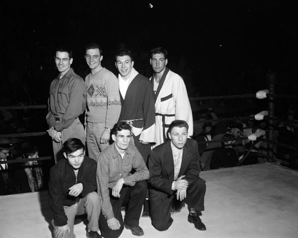 All-University Boxing Champions Portrait of seven of the eight boxers crowned all-university champions at the finals in the University of Wisconsin-Madison Field House. Front row, left to right, are Roy Kuboyama, Hawaii; Carroll Sternberg, Milwaukee; and Terry Tynan, Chicago. Back row, left to right, are: Bob Morgan, Duluth, Minnesota; Bob Meath, New Richmond; Truman Sturdevant, Libertyville, Illinois; and Bob Hinds, Kenosha.