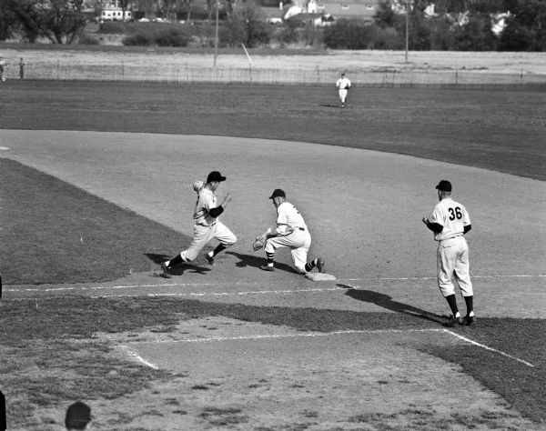 University of Wisconsin vs. Illinois Baseball Game Jim Temp, Badger first baseman, makes a catch to put out the runner, Illinois pitcher Jim Flynn, during a baseball game between the University of Wisconsin and Illinois.