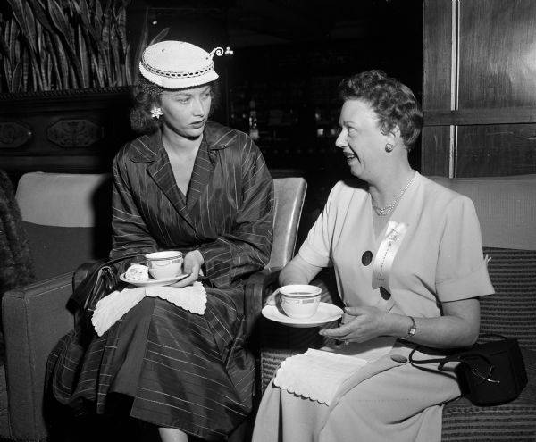 Mrs. Chester Gable of Fontana (left) and Mrs. Chresten Petersen of Clayton socialize during a coffee hour held for wives of Zor Shrine members.