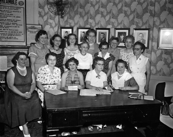 American Legion Auxiliary Group portrait of 14 women making plans for the state convention of the American Legion Auxiliary.
