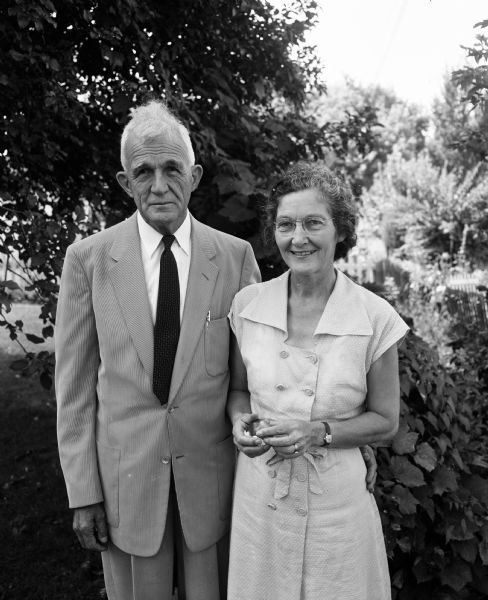 Outdoor portrait of Doctor and Mrs. Paul Harrison, in Madison visiting their daughter and son-in-law Mr. and Mrs. Howard Koop. The Harrisons were medical missionaries in Arabia.