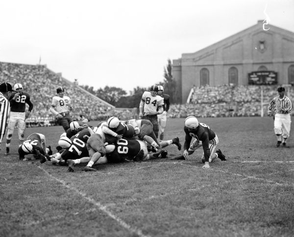 University of Wisconsin vs. Rice Football Game Action shot during the University of Wisconsin vs. Rice football game at Camp Randall. University of Wisconsin player Alan Ameche (on top of pileup in center) scores Wisconsin's first goal of the game.