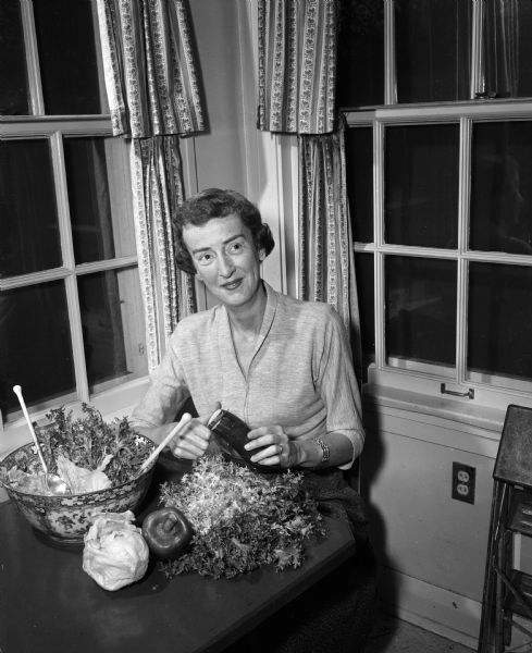 Lucia Leach in her home prior to a University of Wisconsin pregame party. She will be serving baked ham, scalloped potatoes, a green salad, rye bread, and chocolate cookies.