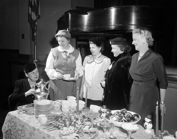 Catholic Woman's Club members host a tea for new members. They include, from left to right: Johnette Finnegan, President (pouring tea), Elizabeth Teslaw, Mrs. John McKeon, Mrs. J.J. Burke, Kathleen Hall.