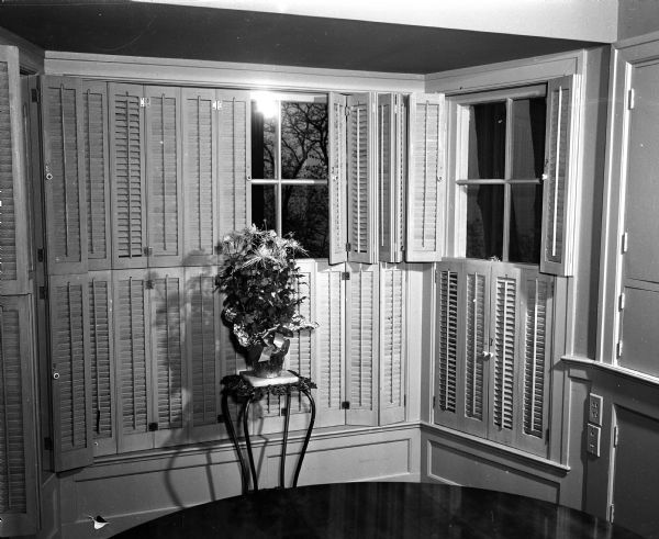 Interior Window Shutters Adjustable wooden shutters cover a bay window at the home of Louis C. McGann on Lake Mendota Drive.
