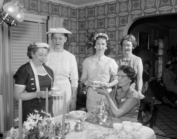 United Givers Women's Division Leaders United Givers district chairman Jeanette Erickson serves coffee to other district or division chairmen. Standing, left to right, are: Lucille Nedrebo, Moodie Brockett, Florence Gately, and Kathleen Joachim.