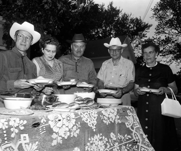 Leo J. Merkel of 1925 West Lawn Avenue; Mrs. Hal Halfmamn of 440 Marston Avenue; Mr. Halfman; A. J. Sticha of 1109 Ridgewood Avenue, and Mrs. (Margaret) Sticha stand in the "chow line" at the Lions Club Rodeo Barbecue at No-Oaks Ranch on Syene Road.