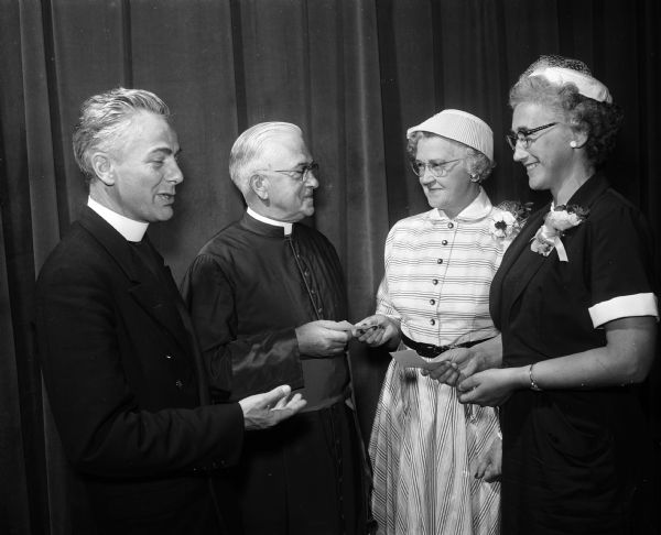 Members of the Queen of Peace Church Women's Catholic Order of the Foresters Pearl Gaffney (left) and Laura Ostrowsky present a check for $500 for the Baptismal Font to, (left to right): Father Lawrence Clark, associate pastor of Queen of Peace, and Monseigneur Francis L. McDonnell, pastor of Queen of Peace.