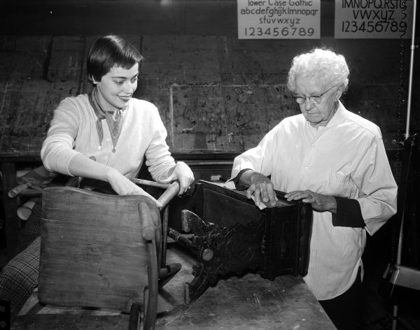 Men and women are learning how to fill the long hours of ever-mounting leisure time in modern living at the Madison Vocational and Adult Education School. Mrs. Graham U. (Penelope) Johnson, 22 Burrows Road, a 24-year-old recent bride, works side-by-side in the caning and refinishing class with Mrs. Augusta Binger, 2706 Sommers Avenue, who is 84 years old.