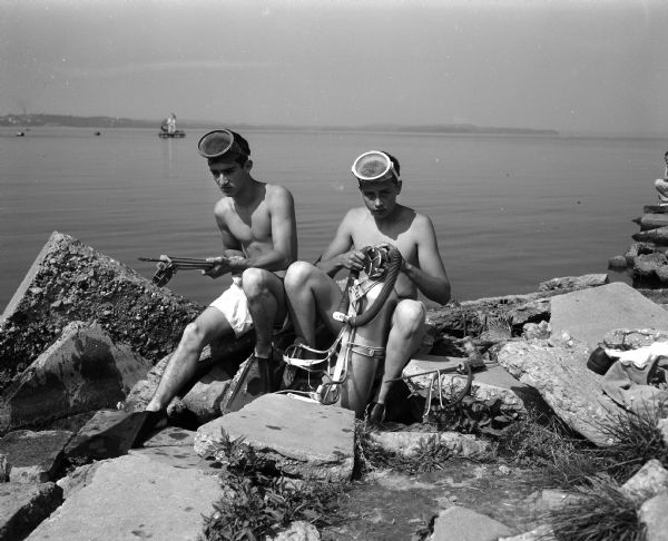 Dick Charmley and Gary Davies examining their apparatus for skin diving and spear fishing in Lake Mendota.