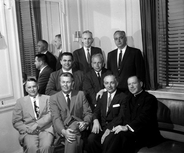Military Order of the World Wars Officers Group portrait of the new officers of the Military Order of the World Wars. Front row, left to right: Lt. (Justice) Timothy Brown, judge advocate; Brig. Gen. Collins Ferris, past commander; Atty Maurice Pasch, new commander; and the Rev. Austin Henry, chaplain. Second row: Major Arlie Mucks, vice-commander; and Col Edward P. Roemer, surgeon. Top row: Capt. Eugene Mordby assistant surgeon and Capt. William Curkeet, vice-commander.