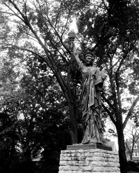 Damaged Statue of Liberty Replica A bullet-hole struck the space beneath the left eye of the Statue of Liberty in Giddings Park on East Gorham Street. The statue was a gift to the Boy Scouts from the Madison Rotarians; it was restored and relocated to Warner Park.