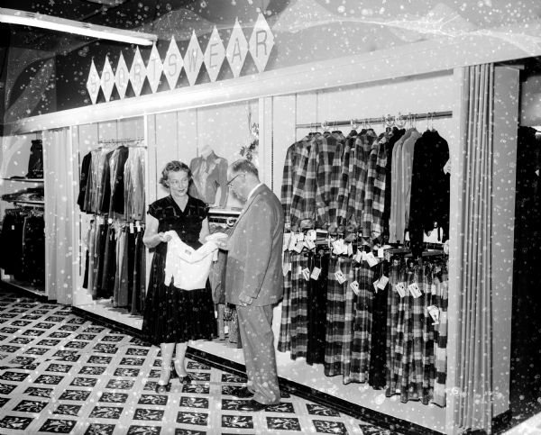 Baron Brothers Department Store Remodeling Interior view of Baron Brothers Department Store after remodeling. Joseph Rothschild, a partner of the firm, is standing with Freda Kitson, manager of the new sportswear department.