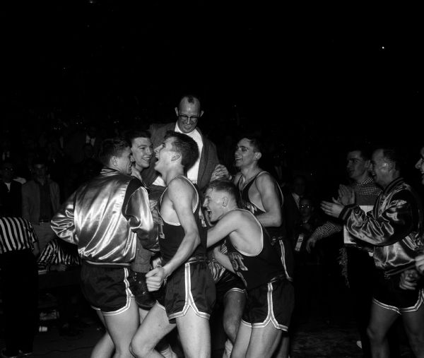 State Basketball Tournament Winners Coach Verlyn Belisle is mobbed by his Madison East players moments after they had won the state high school basketball championship. The players, left to right, are: Tom Handford, Pat Richter, Dave Heisig, Dale Holzhuter, and Ron Staley.