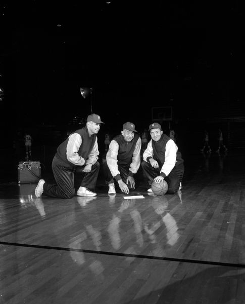 University of Wisconsin Basketball Coaches University of Wisconsin basketball coaches kneel on the court. Head coach Harold "Bud" Foster is starting his twenty-fifth year.