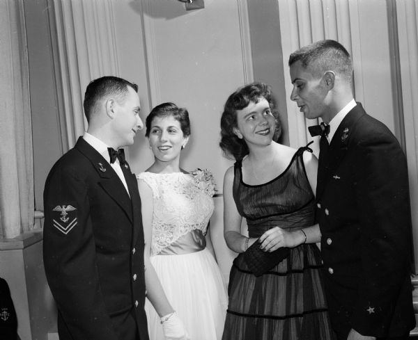 Two midshipmen and their dates attend the Navy Ball held for the Naval Reserve Officers Training Corps (NROTC) midshipmen at the Memorial Union's Great Hall. They are Dick Pearl (Green Bay), financial secretary for the ball, and Judie Baron (Racine) at left. On the right are Sandra Montgomery (Milwaukee) and Bill Anderson (Houston, Tex.).