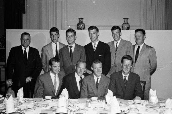 Group portrait of eight young "Vikings" who have come to Madison to be named as Thomas E. Brittingham Viking Scholar students at the University of Wisconsin. Seated left to right: Ralf Torngen, Helsinki, Finland; Helge Pedersen, Oslo, Norway; John Simonsen, Oslo and Frederik Eklof, Helsinki. Standing left to right: Bernhard Mautz, Madison; Staffan Berglund, Stockholm, Sweden; Niels Hoegh-Guldberg, Copenhagen, Denmark; Flemming Luttichau, Jutland, Denmark; Nils Frisk, Stockholm, Sweden and Henry Behnke, Madison. Thomas Brittingham Jr. died April 16, 1960. The Brittingham Scholars program, founded in 1953 continued through 1962.