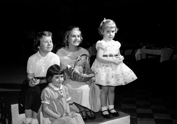 Four of the daughters who modeled in the Elks Club fashion show are: Marie Louise Durand, daughter of Mr. and Mrs. Bert (Ethlyn) Durand, 4126 Mandan Crescent, seated in front. Behind her, left to right, are Sally Foye, daughter of Mrs. Molly Foye, 3606 Monroe Street; Jane Gallagher, daughter of Mr. and Mrs. James (Edith) Gallagher, 4133 Paunack Avenue and Laurie Lynn Ottum, daughter of Mr. and Mrs. James (Marian) Ottum, 2805 Commercial Avenue.