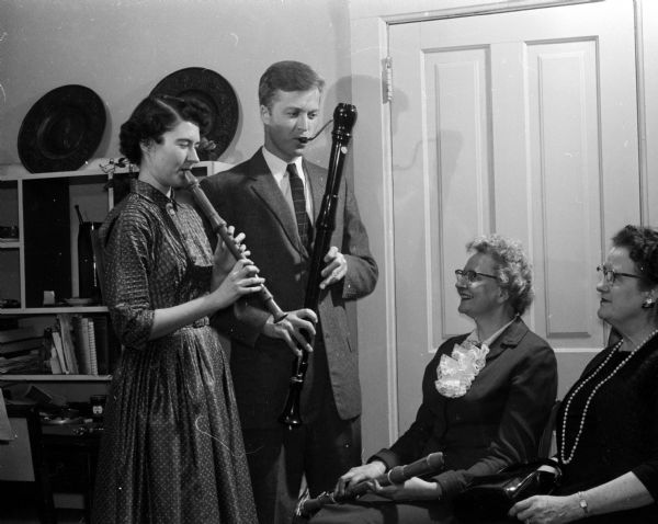 A program by the Madison Recorder group and the Madison Folk Dance group will be featured at the inter-city meeting of representatives from Zonta Clubs of District VI. Helen Crawford, president, and Sayda Pettersen, general chairman of the inter-city meeting, are shown listening to two from the Recorder group, Virginia Nye (recorder) and Robert Savage (bassoon).