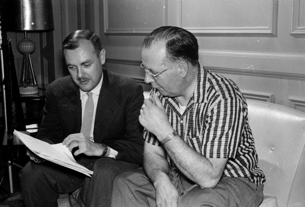 Philharmonic Rehearsal The Philharmonic Chorus of Madison will give the first performance of a work by Professor Robert Crane, a member of the University of Wisconsin music faculty, on April 15. Professor Crane and Professor Bernhardt Westlund of Milton College, the chorus director, go over the manuscript of "A War Song to Englishmen".