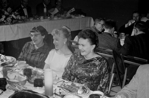 Jean Krieser (left), Betty Larson, and Mary Jane Johnson (all bank employees) attending the annual dinner meeting.
