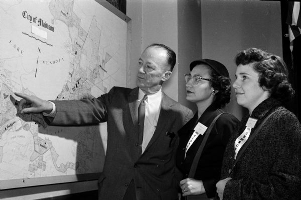 Lloyd Benson, census director for the Madison board of education, points to a map with two of the forty-seven census takers, Mrs. Roberta Kiesow (center) and Mrs. Donna Bossenberry, standing nearby. The census information will be used for the next year's school planning.