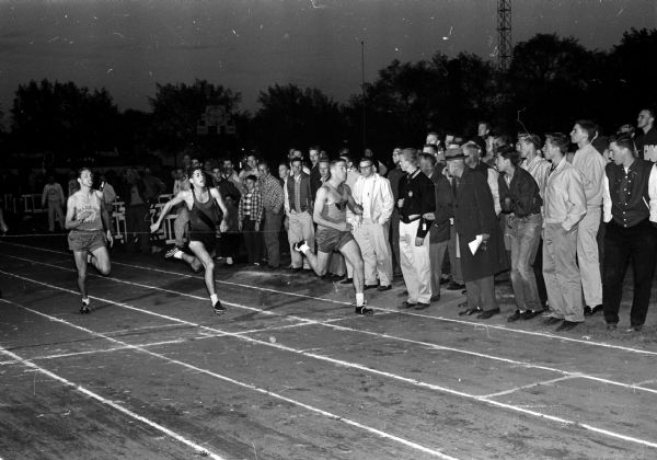 Finish of the 100-yard dash at the Big Eight Conference track meet. Left to right are: Bill Smith of Madison East, third; Al Epstein of Kenosha, second; and Howard Mazur of Madison West, first.
