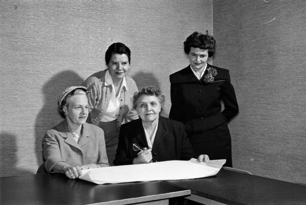 Madison Visiting Nurse Service Officials look over plans for a new office. Left to right are: Mrs. Helen Giessel, board of directors treasurer; Mrs. Virginia Walrath, board president; Ruth TeLinde, director; and Mrs. Guy Martin, house committee chairman.